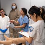 Group of nursing students working in a nursing lab 