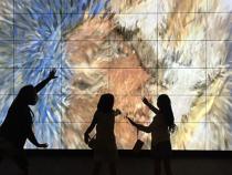 Children interacting with the art installation touch screen