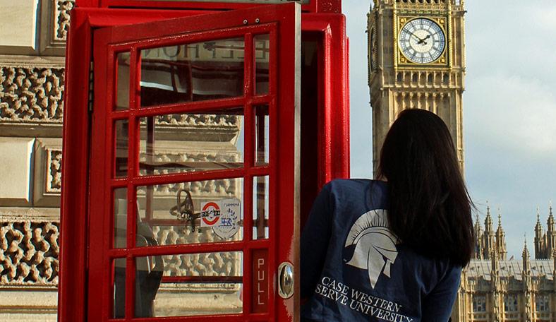 CWRU student leaning out of phone booth in London