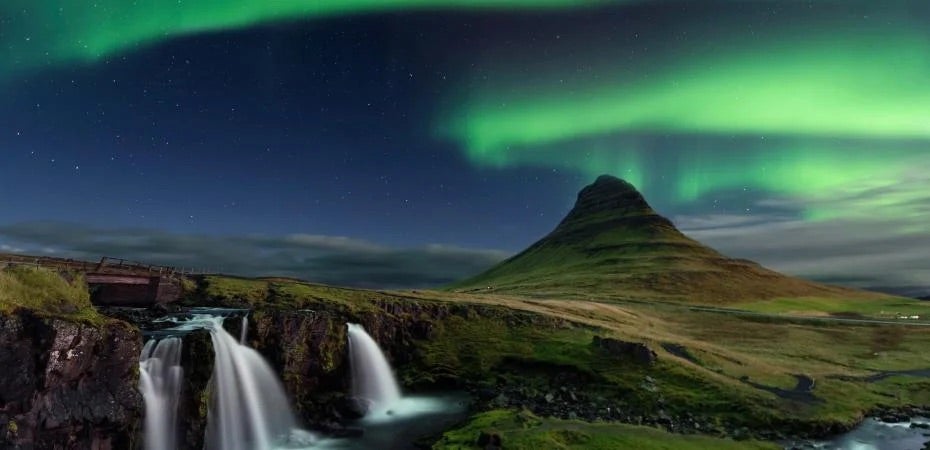 Northern lights over a mountain in Iceland.