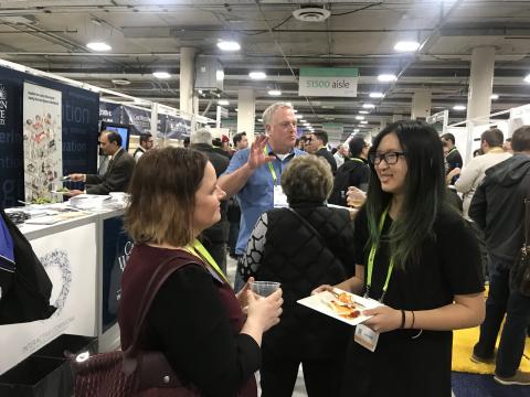 Boar President Allison Olenginski (CWR '01, left) visits with a CWRU student innovator during the 2019 Consumer Electronics Show in Las Vegas. 