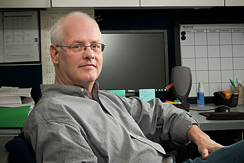 Photo of Dan Flannery sitting at his desk
