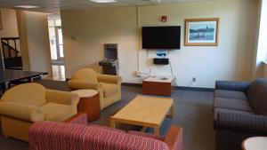 Pierce House Common Room showing furniture, television, and wall-mounted water bottle filler