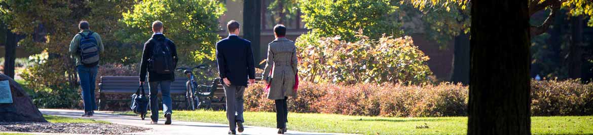 photo of case quad people walking amongst autumn trees