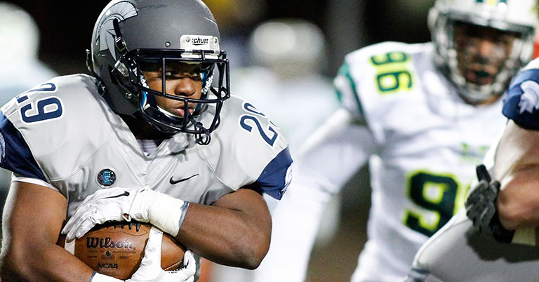Case Western Reserve University football player carrying the ball during a game
