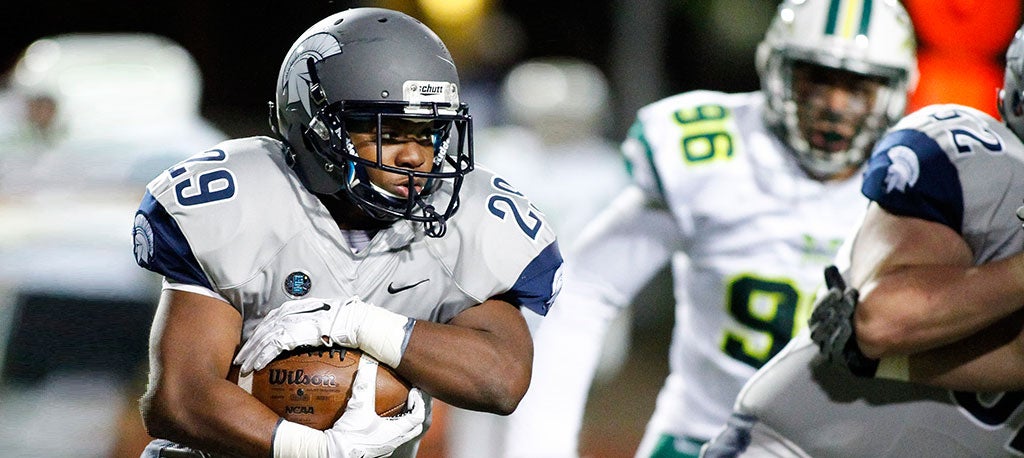 Case Western Reserve University football player carrying the ball during a game