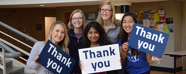 CWRU students holding thank you signs