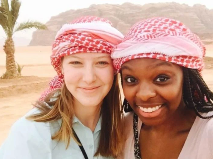 Two women smiling wearing headscarves.