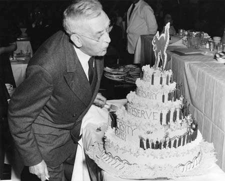 President Leutner blows out candles on the WRU 125th birthday cake, 2/6/1951