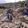 Villagers scour rubble for belongings scattered during the bombing of Hajar Aukaish - Yemen - in April 2015