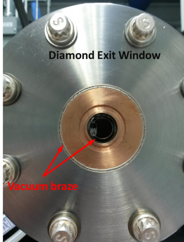 View of the clear diamond exit window that is bonded to a vacuum flange.