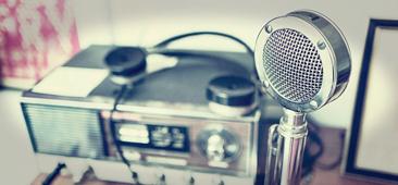 Picture of an antique radio broadcasting unit with old time microphone