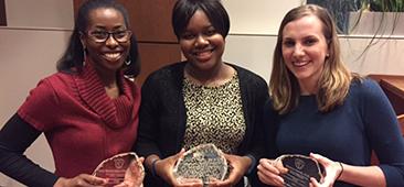 Picture of three professionals displaying their awards for Academic Medical Excellence