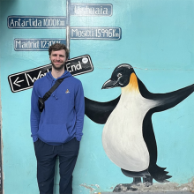 Ian Dorney standing next to life size penguin painting