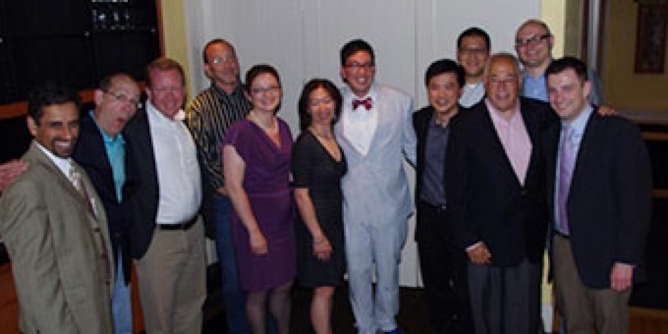 Dr. Nathaniel Liu Graduation, 2014 with twelve people in dress attire 