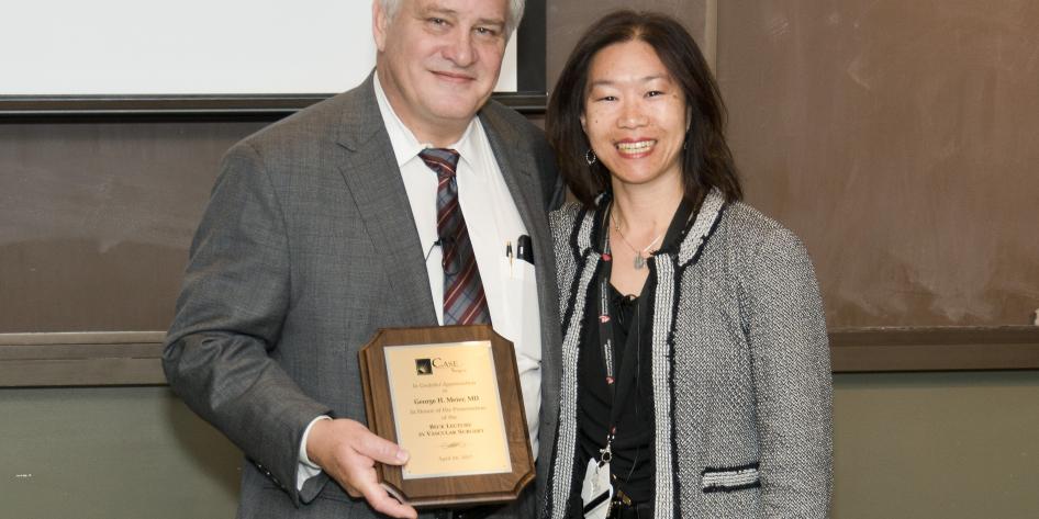 Photo of George H. Meier with Virginia Wong after giving his Beck Lecture in Vascular Surgery talk. Dr. Meier is holding a plaque.
