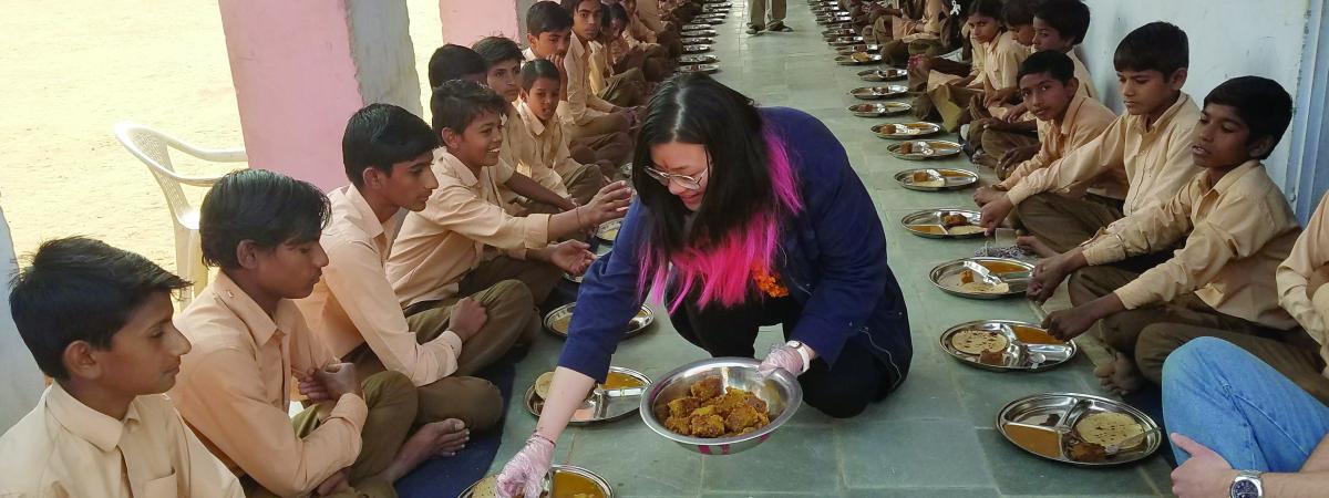 Student serving dinner in India