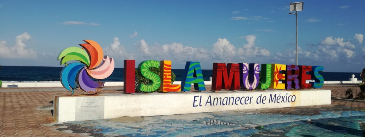 Colorful sign for Isla Mujeres on beach