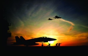 A silhouette of planes and pilots during a sunset