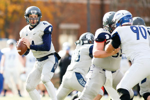 CWRU football player holding the ball getting ready to throw