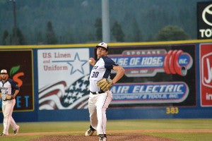 A CWRU male baseball pitcher winding up for a throw