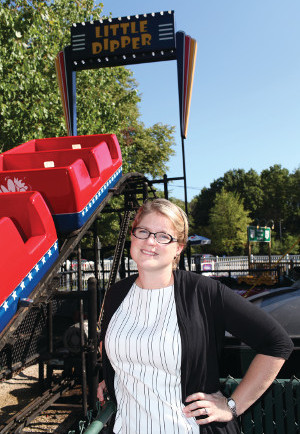 A photo of CWRU faculty Jennifer Carter standing in front of a roller coaster labeled Little Dipper