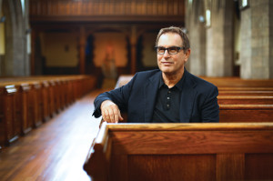 A photo of CWRU professor David Cooperrider sitting in a church pew