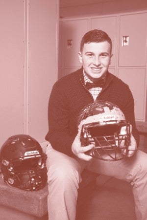 Headshot of Dominic Barandica holding a football helmet