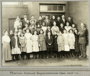 Students standing in front of a school