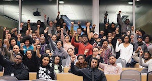 CWRU students, faculty, staff and alumni of African descent raising their right fists in the air at the Convening in 2016
