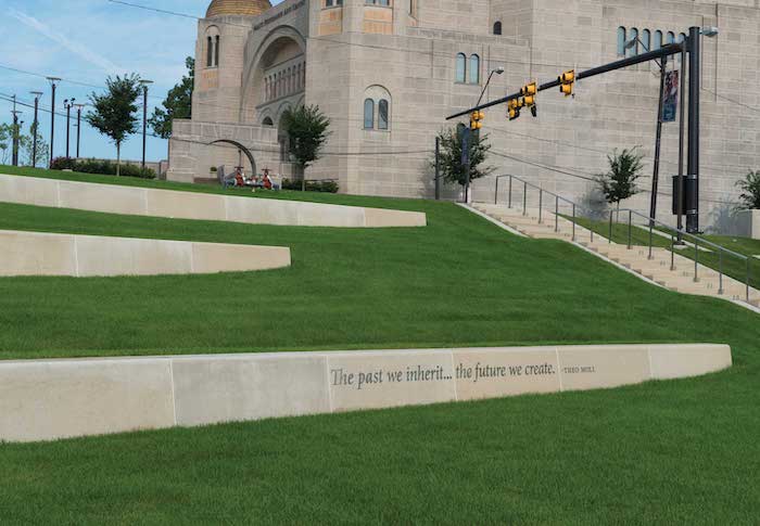 Close up of a quote by Theo Moll engraved at the greenway's western edge that reads 'the past we inherit … the future we create.'