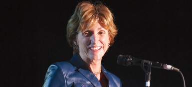 Photo of Barbara R. Snyder standing on a stage next to a microphone.