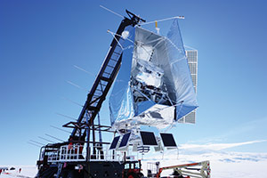 A large telescope suspended by a crane-like structure.
