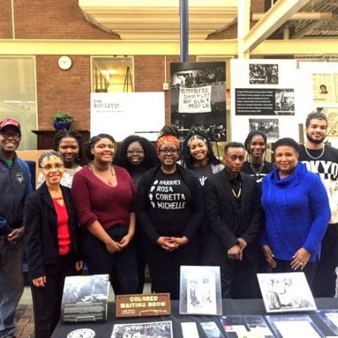 Members of the Black Student Union pose with memorabilia from the Black History 101 Mobile Museum
