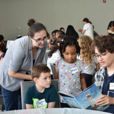 A CWRU student reads a picture book to an elementary-school student for his first-seminar course.