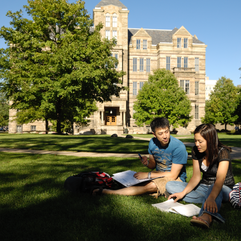 Students sitting on lawn in front of Adelbert Hall