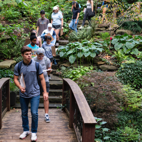 A class of students walking through the Cleveland Botanical Gardens