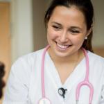 Nursing student in uniform talk to patient