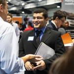 Student talking with someone at a career fair 