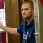 Male nursing student performing an eye test