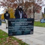 A sign in the round on campus advertising study abroad 