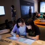 Two female students looking at the same screen 