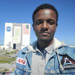 Photo of Jamie Booker in front of Kennedy Space Center in Florida