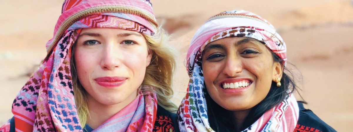 two girls abroad smiling