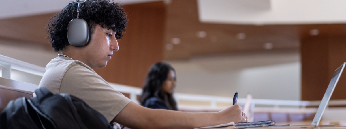 Student studying with headphones on