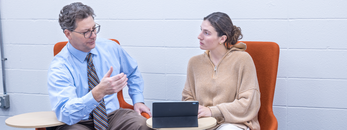 Student talking with a professor