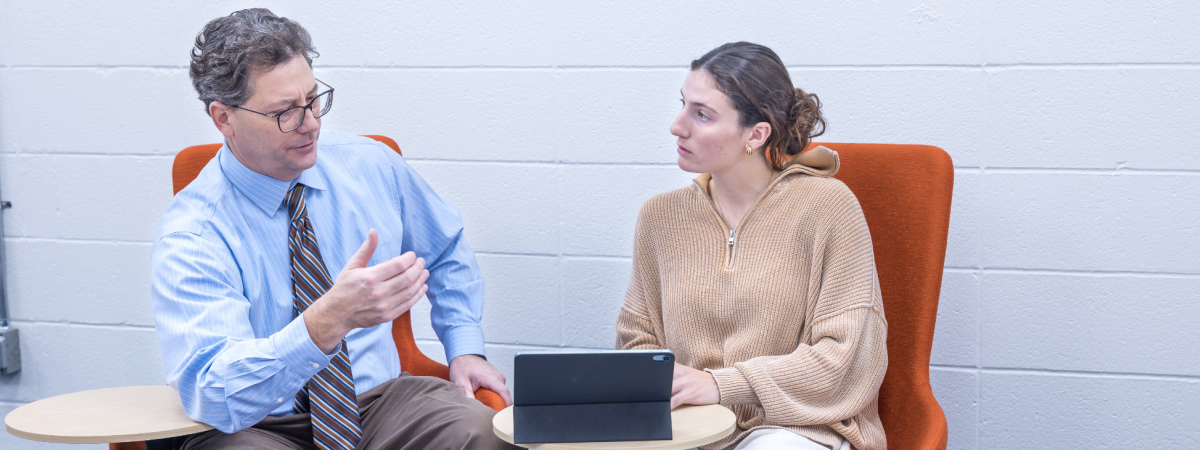 Student talking with a professor