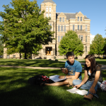 Students sitting on lawn in front of Adelbert Hall