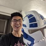 a student holding star wars helmet he made