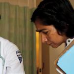 A female presenting African American nursing students works with faculty 